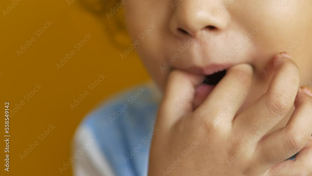 child girl putting a candy in her mouth child girl putting a candy in her mouth