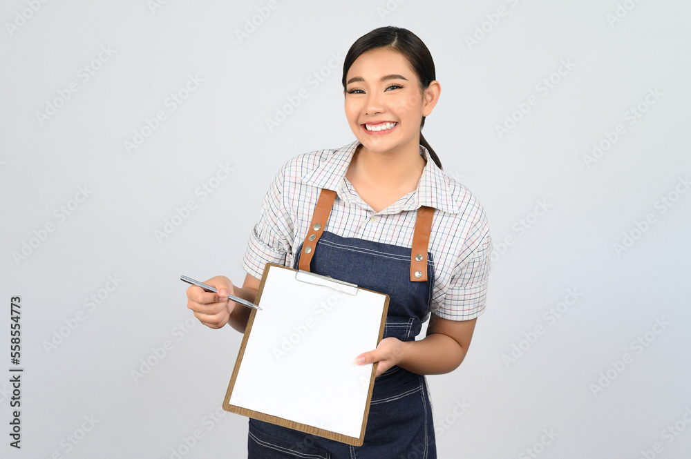 Portrait of young asian woman in waitress uniform pose with clipboard Portrait of young asian woman in waitress uniform pose with clipboard