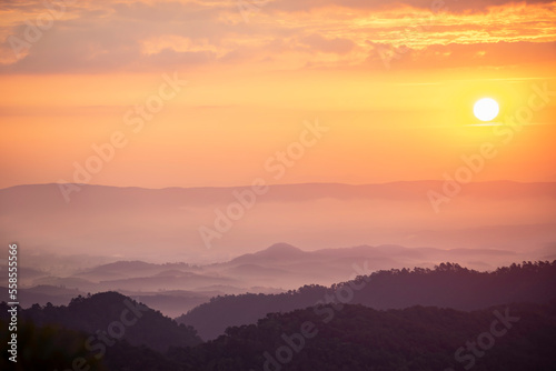 An image landscape forest layer mountain and fog or mist with sun in the travel day vacation in the tourist in start the day winter atmosphere background.
