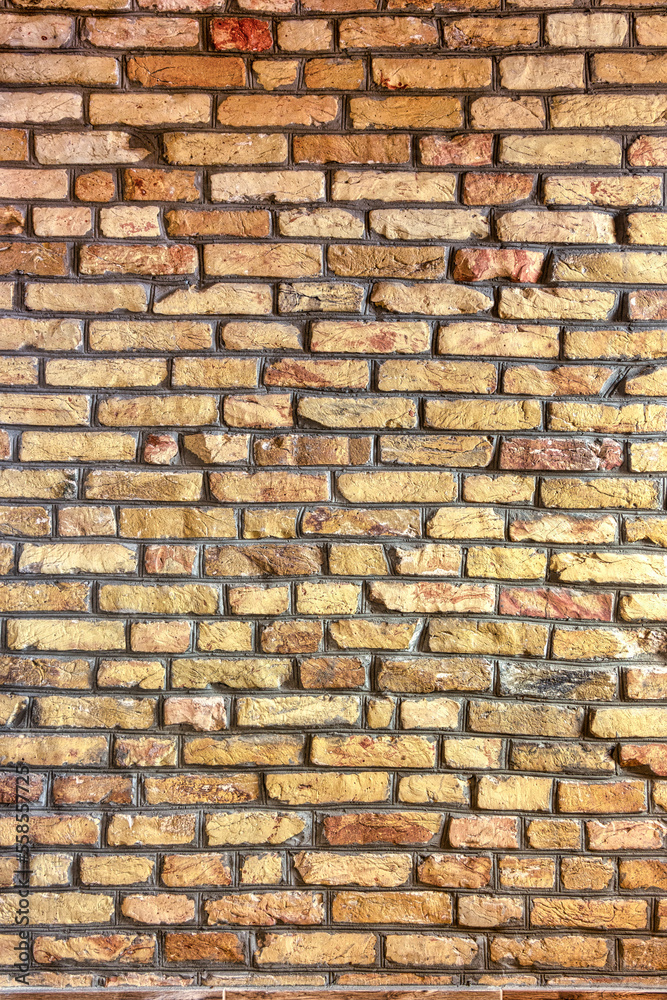 Obraz premium A brick wall, made of treated, antique-styled brick.