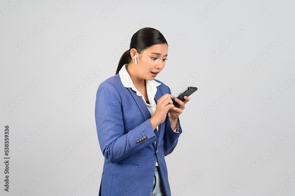 Young beautiful woman in formal clothing for officer use earphone Young beautiful woman in formal clothing for officer use earphone