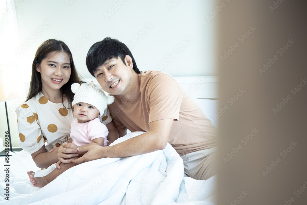 Portrait of Asian parents newborn baby day, Closeup portrait of asian young couple father mother holding new born baby in hospital bed. Portrait of Asian parents newborn baby day, Closeup portrait of asian young couple father mother holding new born baby in hospital bed.
