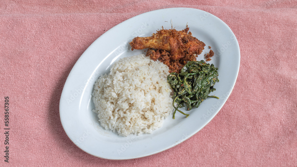 Ayam goreng Kalasan and Gulai daun ubi, Indonesian traditional cuisine made from fried chicken Ayam goreng Kalasan and Gulai daun ubi, Indonesian traditional cuisine made from fried chicken
