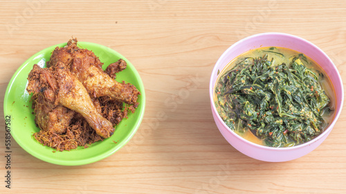 Ayam goreng Kalasan and Gulai daun ubi, Indonesian traditional cuisine made from fried chicken photo