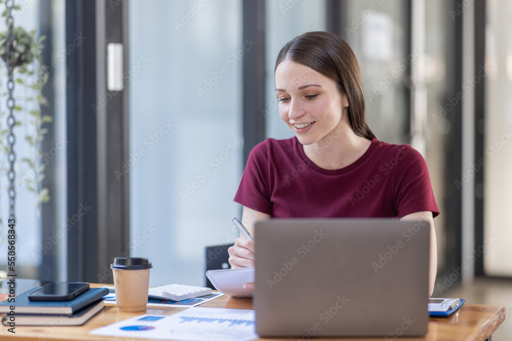 Portrait young canada american woman working on laptop computer in office. documents tax business girl planning analyzing the financial report, business plan investment, finance analysis concept. Portrait young canada american woman working on laptop computer in office. documents tax business girl planning analyzing the financial report, business plan investment, finance analysis concept.