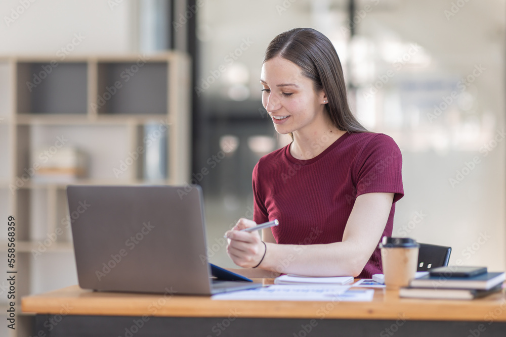Portrait young canada american woman working on laptop computer in office. documents tax business girl planning analyzing the financial report, business plan investment, finance analysis concept. Portrait young canada american woman working on laptop computer in office. documents tax business girl planning analyzing the financial report, business plan investment, finance analysis concept.