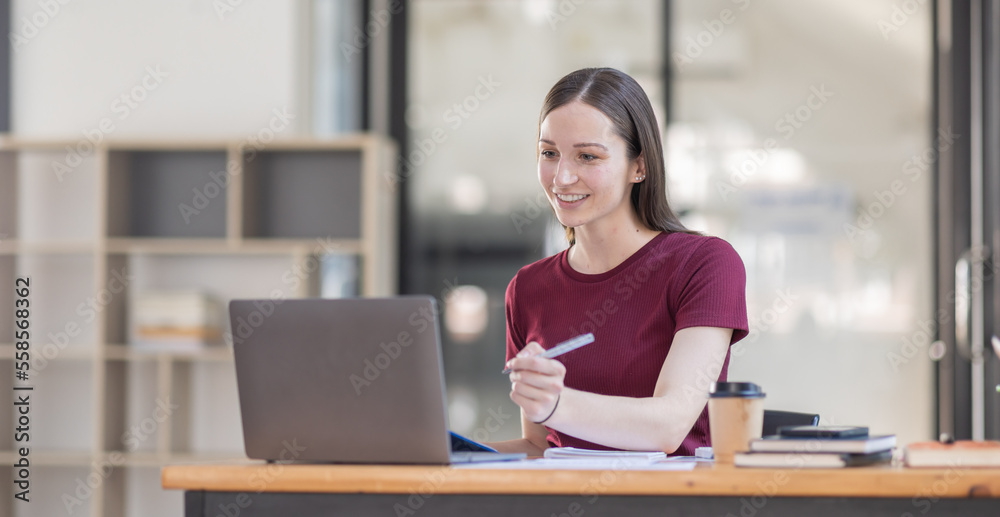 Obraz premium Portrait young canada american woman working on laptop computer in office. documents tax business girl planning analyzing the financial report, business plan investment, finance analysis concept.