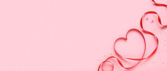 Heart made of red ribbon on pink background with space for text. Valentine's Day celebration