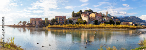 Old Residential Homes near river and sea in Ventimiglia, Italy. Sunny Fall Season. Day time. Panorama