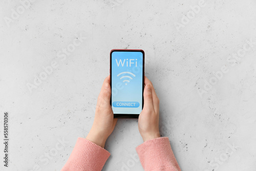 Woman holding mobile phone ...