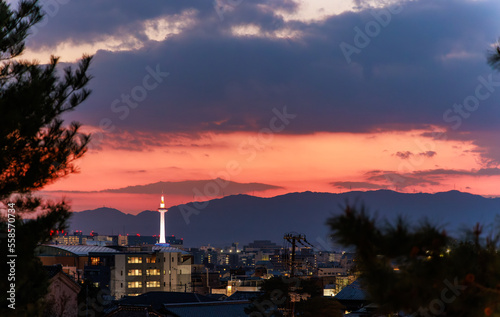 Orange sunset glow over Kyoto buildings and tower