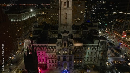 Philadelphia City Hall. Rising aerial reveal from Christmas tree and decorated with lights to night view of city. photo