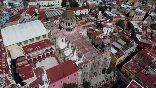 Church with churrigueresque facade among buildings with red roofs in Guanajuato, Mexico photo