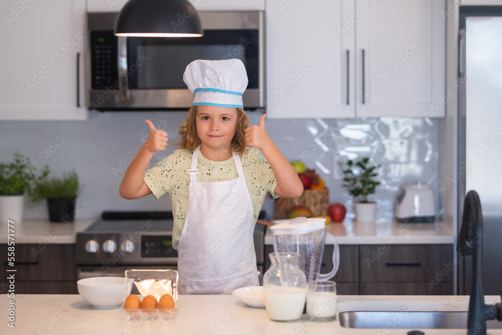 Kid chef cook cookery at kitchen. Cooking, culinary and kids. Little boy in chefs hat and apron. Kid chef cook cookery at kitchen. Cooking, culinary and kids. Little boy in chefs hat and apron.