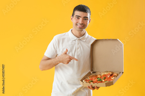 Young man pointing at box o...