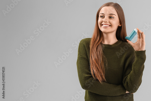 Smiling young woman holding...