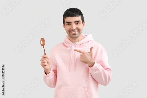 Young man with golden spoon...