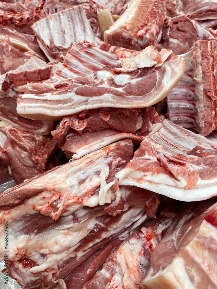 Meat texture chunks arranged in a row in a large in the meat market. Selective focus. Vertical photo