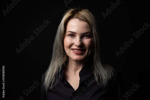 Elegant blonde beautiful middle aged lady posing, smiling to the camera. Attractive businesswoman.