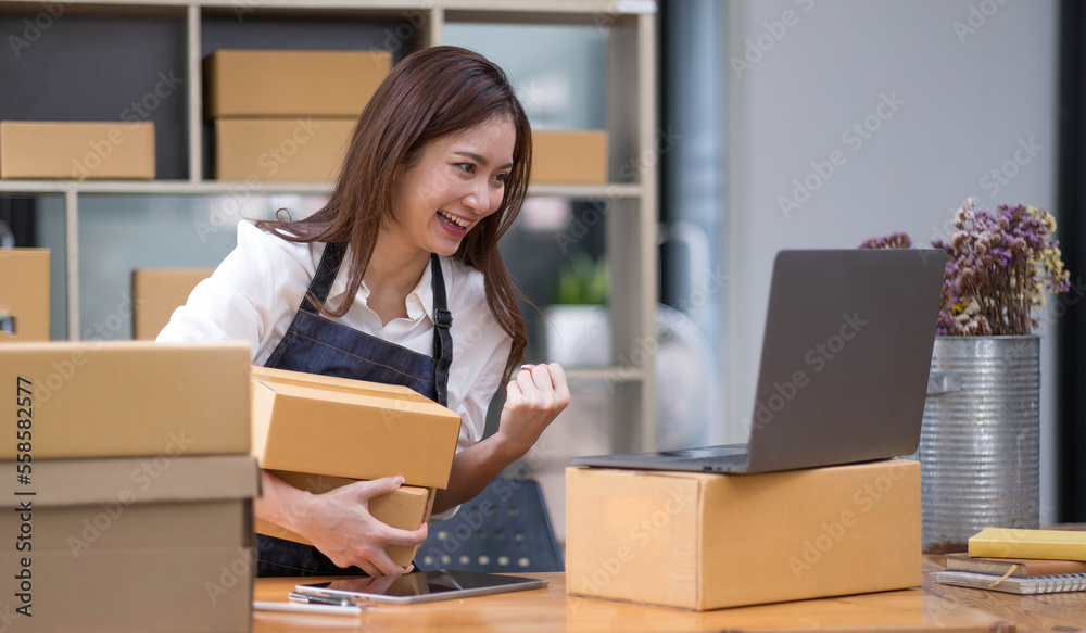 Successful entrepreneur business woman with online sales and Parcel shipping in her home office.