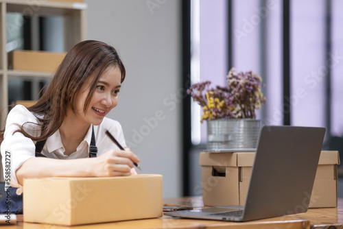 Successful entrepreneur business woman with online sales and Parcel shipping in her home office, prepare parcel box of product for deliver to customer.