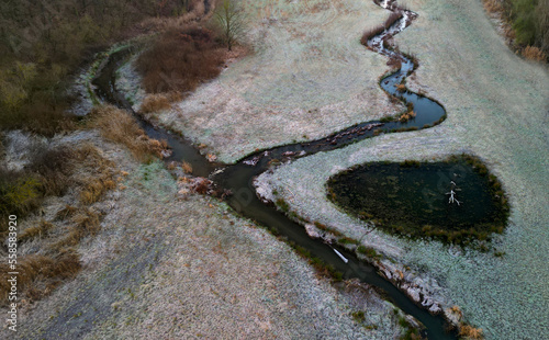 garden park, land with winding stream and ponds. a ford with a road and a wooden bridge across the river. formerly this stream flowed in a straight, straightened watercourse. people restored winding