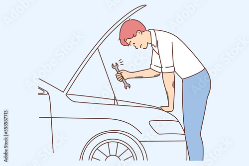 Young man repair car with tool