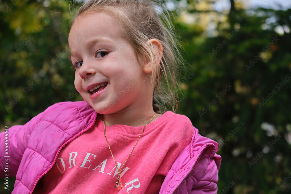 Portrait of a happy adorable smiling little girl outdoor in green city park Portrait of a happy adorable smiling little girl outdoor in green city park