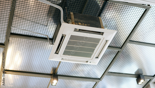 Ceiling mounted cassette type air conditioner for large rooms, exhibition room, Modern cafe © Jirawatfoto