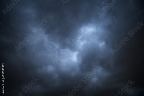 Storm clouds floating in a rainy day with natural light. Cloudscape scenery, overcast weather above blue sky. White and grey clouds scenic nature environment background