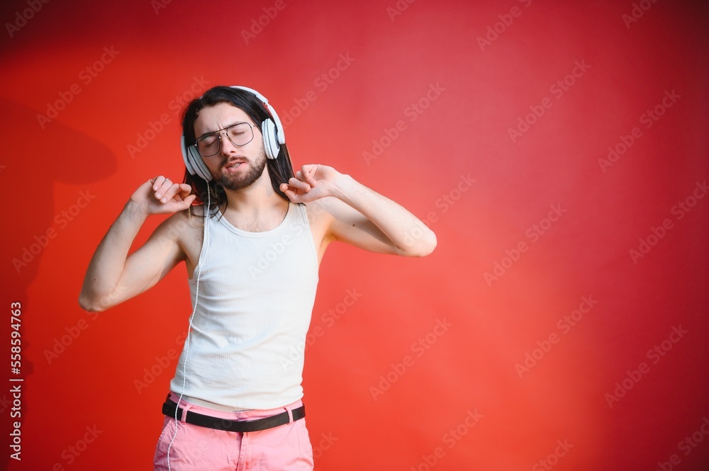 Obraz premium Portrait of a gay man on a colored background. Gender equality. The concept of the LGBT community. Equality.