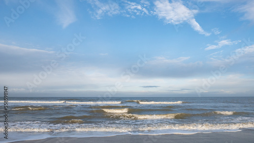 panorama of the North Sea in winter in the weak light of the morning sun with partly cloudy sky in Oostkapelle in Netherlands