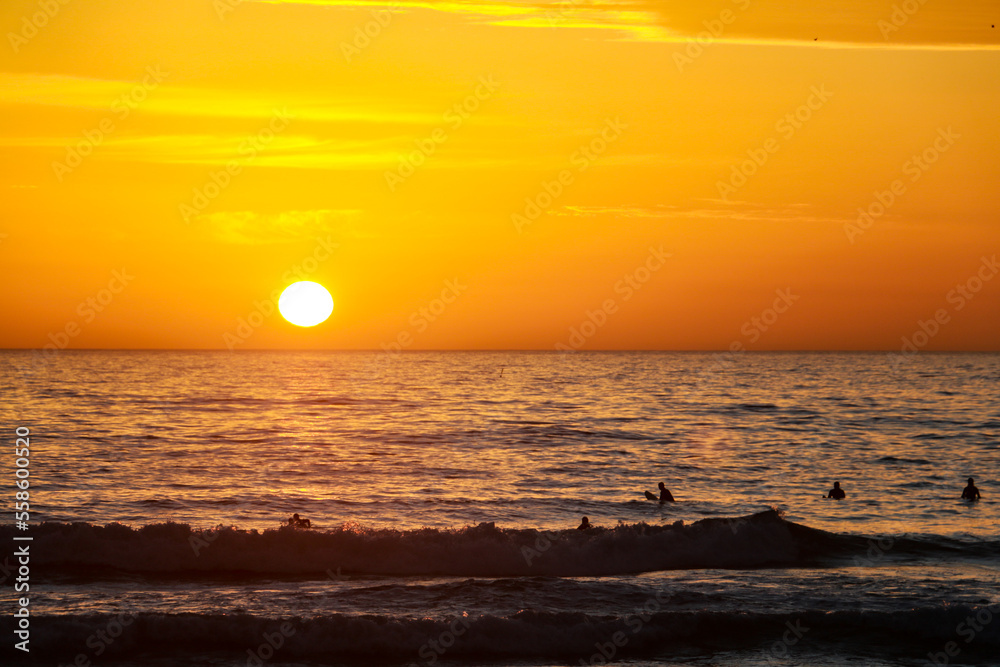 Beautiful sunset at the beach in portugal at the atlantic ocean close to lissabon. Wallpaper surf