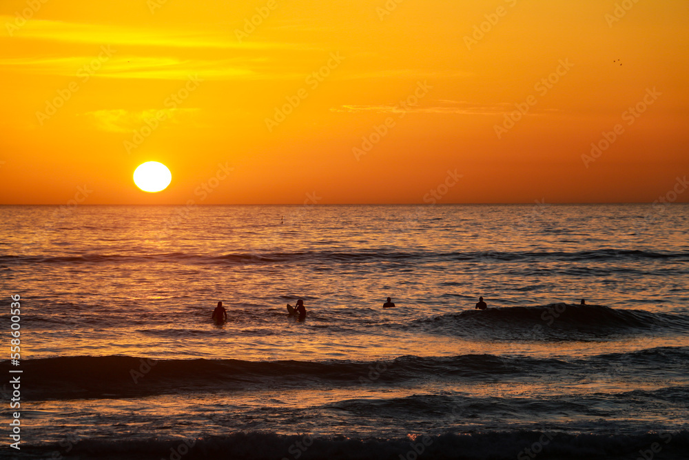 Beautiful sunset at the beach in portugal at the atlantic ocean close to lissabon. Wallpaper surf