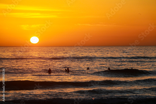Fototapeta Naklejka Na Ścianę i Meble -  Beautiful sunset at the beach in portugal at the atlantic ocean close to lissabon. Wallpaper surf
