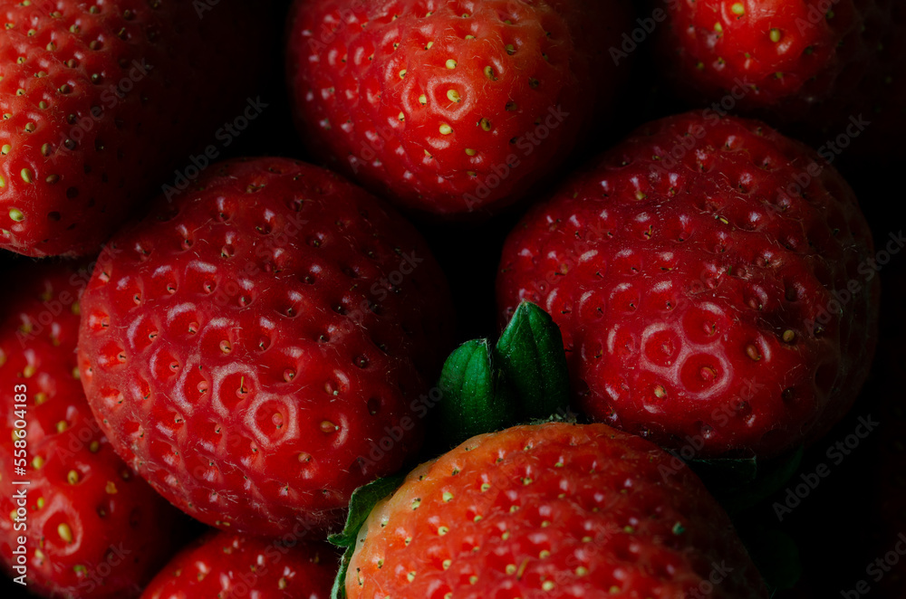 Macro photography of ripe strawberries. Backgrounds and textures. Horizontal photo.