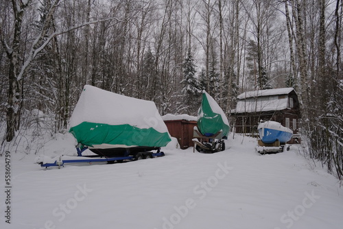 Yacht, boat, ship on the shore under a canopy awning in the snow