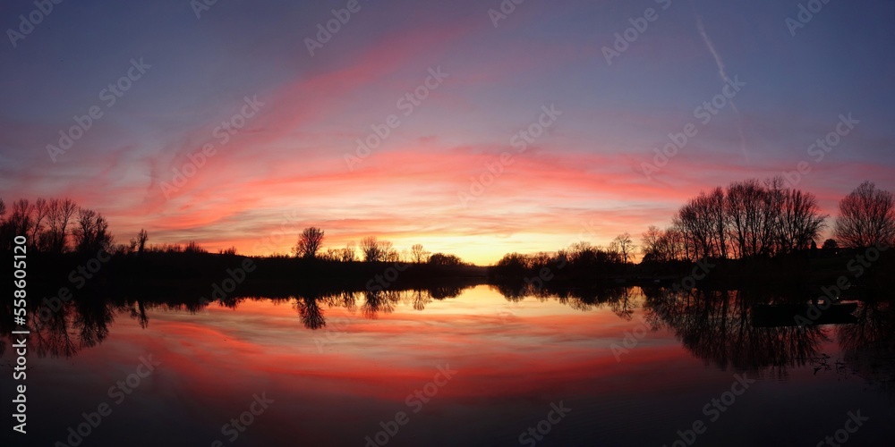 Beautiful colorful sunset with water reflection