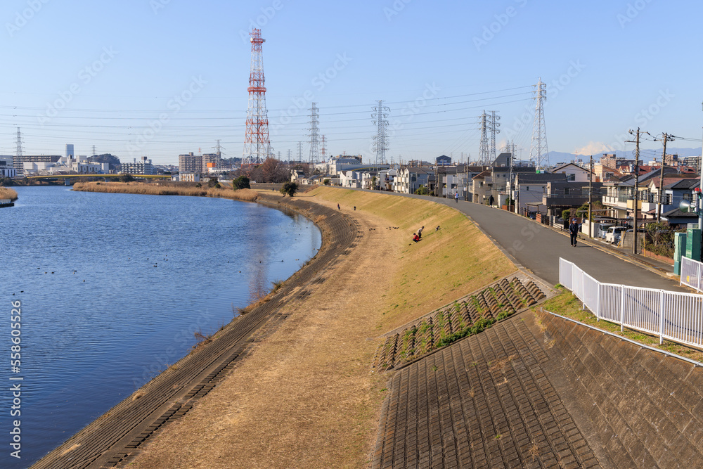 快晴の日の川の堤と街並み