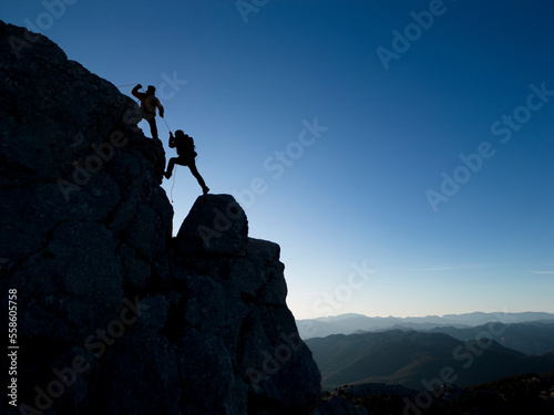 successful climbers in rock climbing with rope