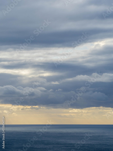 Long aerial view of low storm clouds over Tasman sea coast