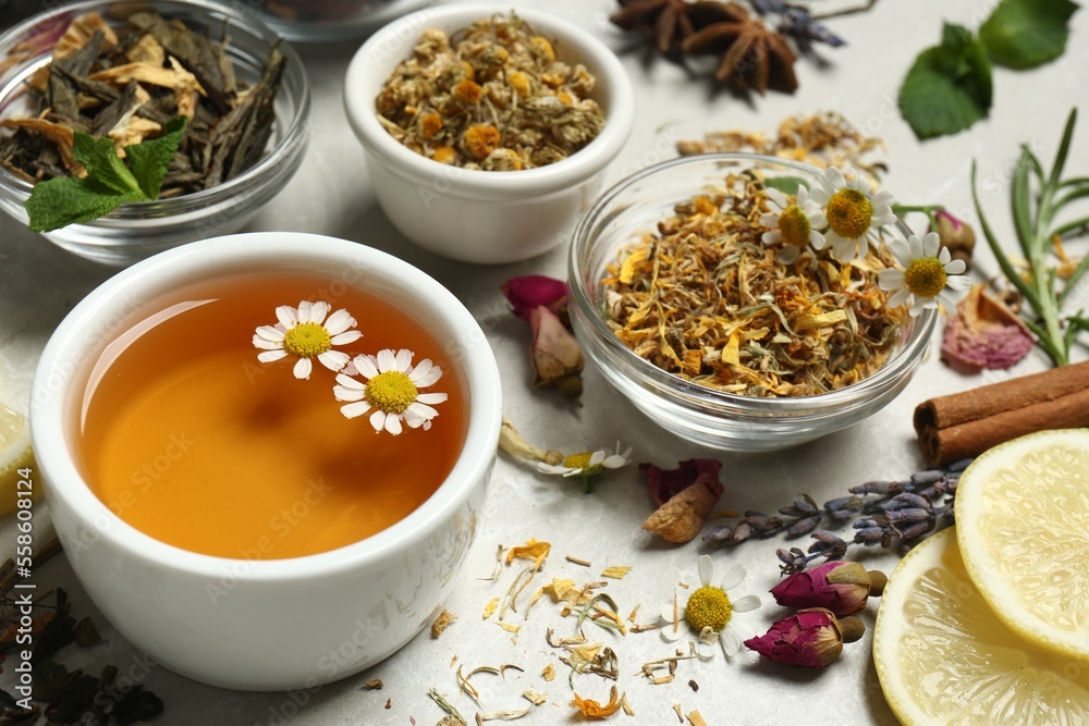Fresh brewed tea and dry leaves on light table Fresh brewed tea and dry leaves on light table