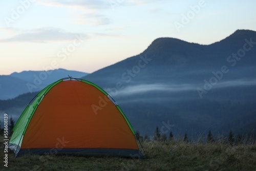 Camping tent in mountains on early morning