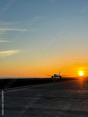 Stunning sunset view of the airplane on a runway in the airport Tenerife Sur, Spain © Lapasmile