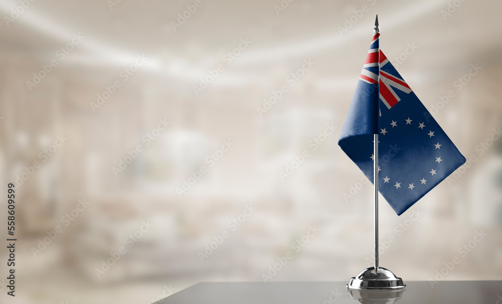 Fototapeta premium A small Cook Islands flag on an abstract blurry background