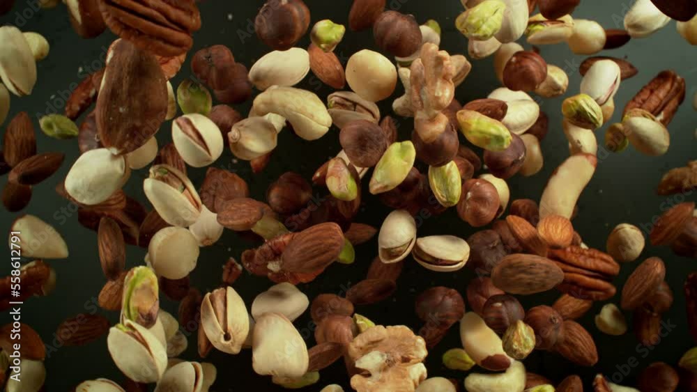 Super Slow Motion Shot of Nut Mixture Rotating and Flying Towards Camera at 1000fps. Super Slow Motion Shot of Nut Mixture Rotating and Flying Towards Camera at 1000fps.