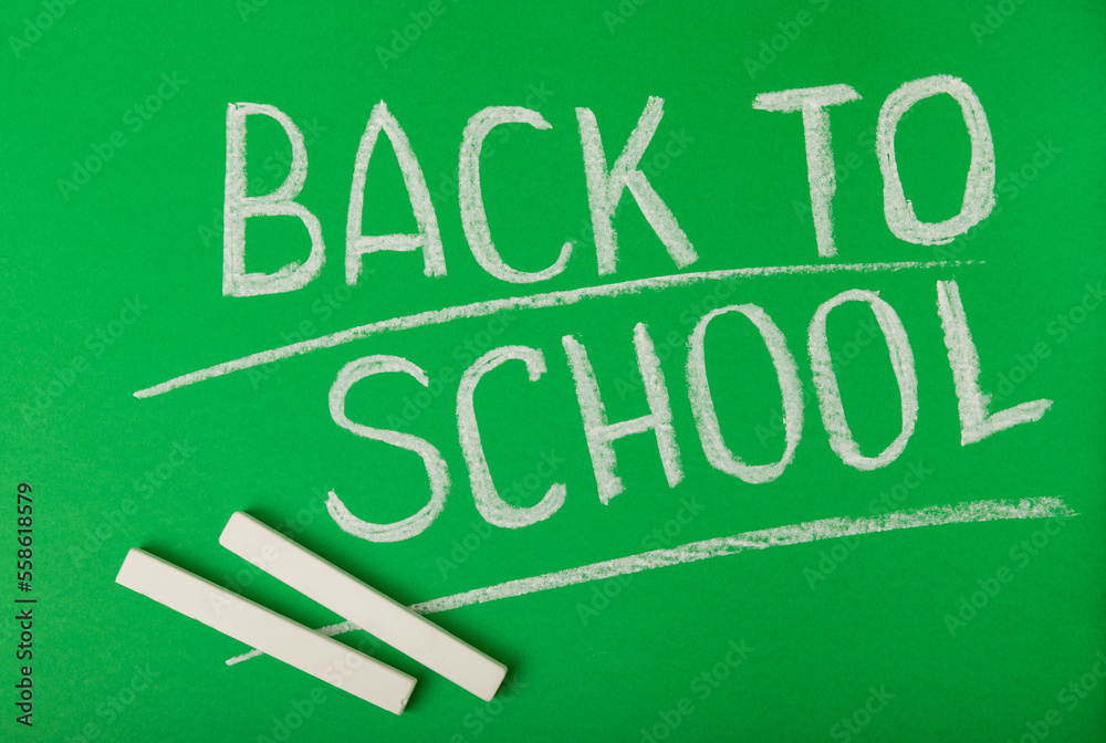 Chalk inscription back to school on a green blackboard. Concept of learning. Chalk inscription back to school on a green blackboard. Concept of learning.