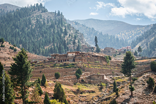 Traditional village houses on the hill in Northern Pakistan photo
