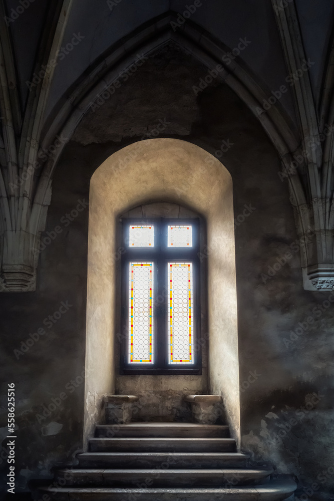 Beautiful window with arch and gothic elements within the Corvin Castle in Hunedoara, Romania.