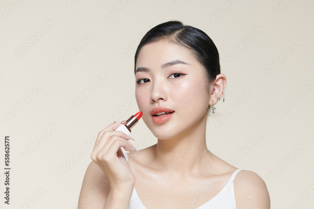 Portrait of gorgeous smiling woman holding red lipstick in hand Portrait of gorgeous smiling woman holding red lipstick in hand